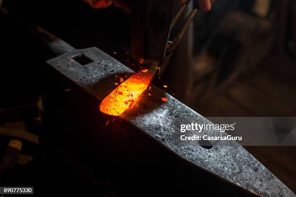 molten knife blade iron on anvil - anvil stock pictures, royalty-free photos & images