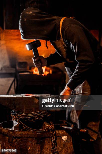 blacksmith forging knife blade on anvil with a hammer - molten stock pictures, royalty-free photos & images