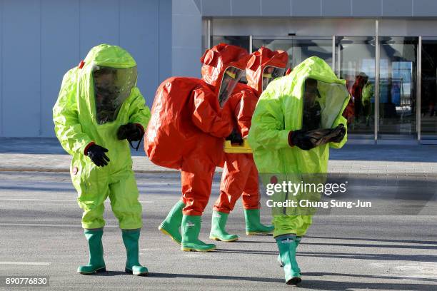 Emergency services personnel wearing protective clothing participate in an anti-terror drill at the Olympic Staduim, venue of the Opening and Closing...