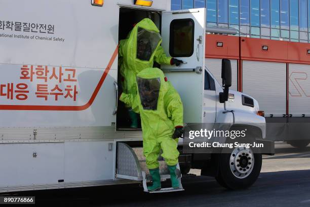 Emergency services personnel wearing protective clothing participate in an anti-terror drill at the Olympic Staduim, venue of the Opening and Closing...