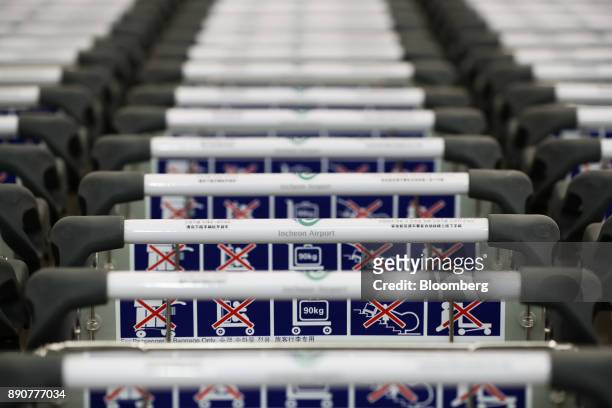 Luggage carts sit inside the nearly completed terminal 2 building during a media preview at Incheon International Airport in Incheon, South Korea, on...