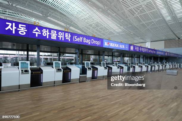 Korean Air Lines Co. Self-service bag-drop counter is seen inside the nearly completed terminal 2 building during a media preview at Incheon...