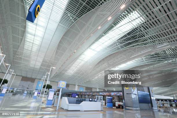 Check-in counters stand inside the nearly completed terminal 2 building during a media preview at Incheon International Airport in Incheon, South...