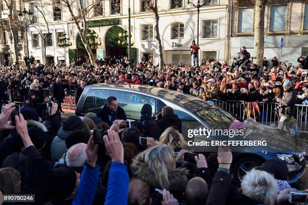 Daughters of late French singer Johnny Hallyday Jade and Joy Hallyday and his wife Laeticia Hallyday walk behind the hearse as it arrives at the La...