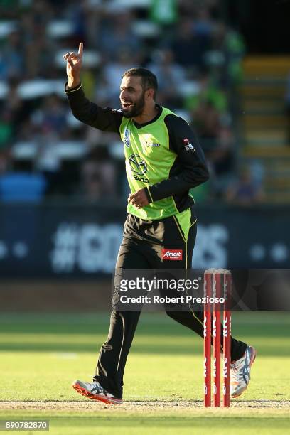 Fawad Ahmed of Sydney Thunder celebrates after taking the wicket of James Faulkner of the Melbourne Stars during the Big Bash League exhibition match...