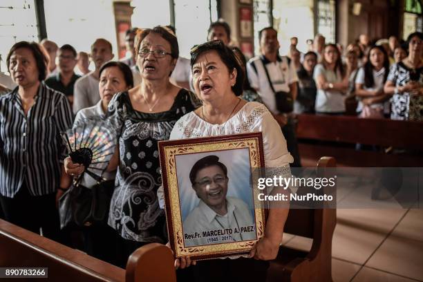 Relative holds a picture of activist priest Fr. Marcelito &quot;Tito&quot; Paez during his funeral in San Jose, Nueva Ecija, north of Manila,...