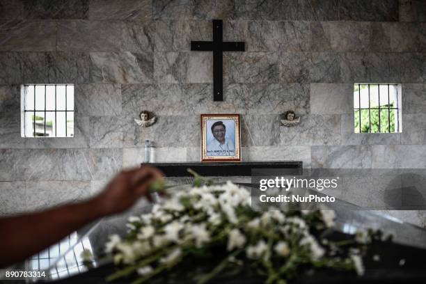 Relative places a flower on the tomb of activist priest Fr. Marcelito &quot;Tito&quot; Paez following his funeral in San Jose, Nueva Ecija, north of...