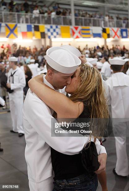 Ian Abbott gets a kiss from his wife Juliann following a Navy boot camp graduation ceremony at Naval Station Great Lakes July 17, 2009 in Great...