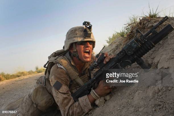 Marine with the 2nd Marine Expeditionary Brigade, RCT 2nd Battalion 8th Marines Echo Co. Yells to other Marines after an IED exploded while they were...