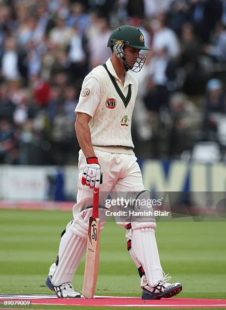 Mitchell Johnson of Australia walks back after being dismissed by Stuart Broad of England during day two of the npower 2nd Ashes Test Match between...