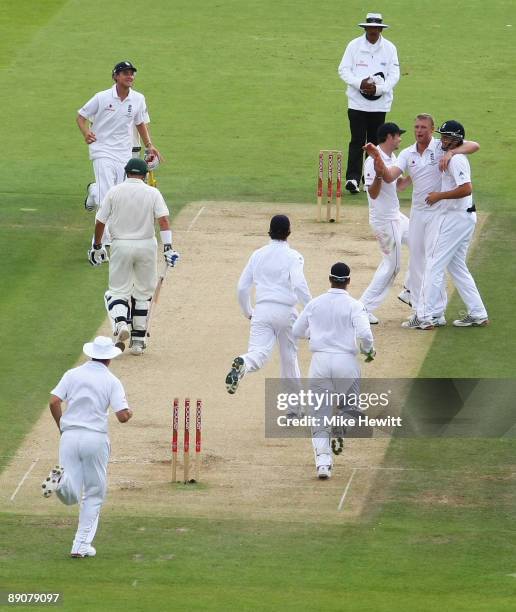 Andrew Flintoff of England celebrates the wicket of Michael Hussey of Australia with team mates during day two of the npower 2nd Ashes Test Match...