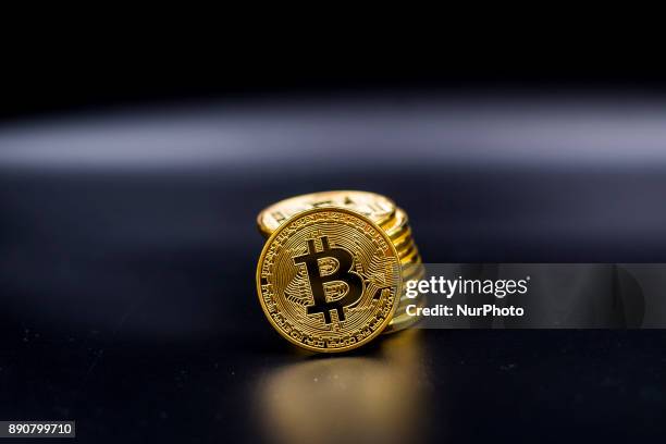 View of Bitcoin physical coin. Futures on Bitcoins increased by more than 20% after their American debut on the Chicago Cboe Futures Exchange.