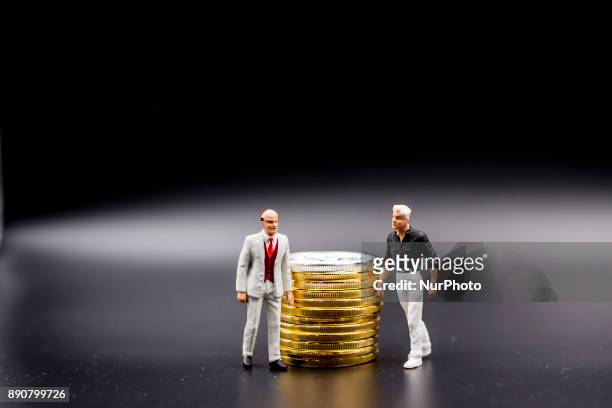Miniature figures near Bitcoin physical coin. Futures on Bitcoins increased by more than 20% after their American debut on the Chicago Cboe Futures...
