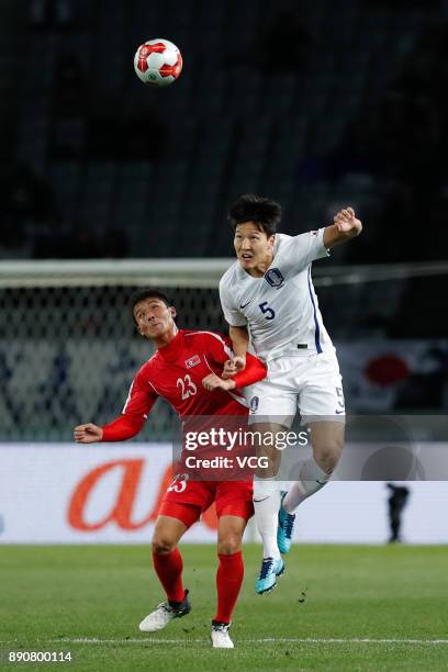 Kim Yu-Song of North Korea and Kwon Kyung-won of South Korea compete for the ball during the EAFF E-1 Men's Football Championship between North Korea...