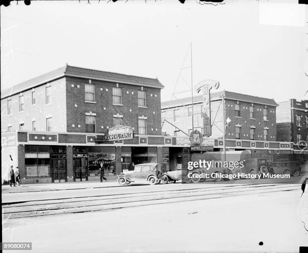 View of the Western Hotel in Cicero, Illinois, viewed at an angle from across the street, 1929. Automobiles are parked in front of the hotel and a...