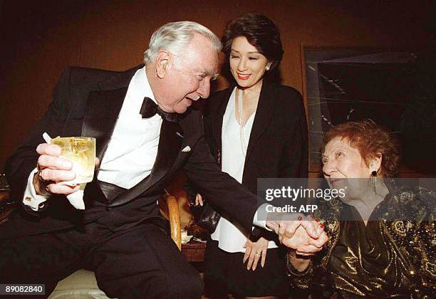 This May 13, 1997 file photograph shows former US television newsman Walter Cronkite speaking to long-time White House reporter Sarah McClendon and...