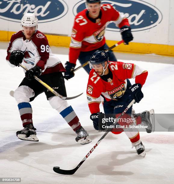 Vincent Trocheck of the Florida Panthers skates with the puck against Mikko Rantanen of the Colorado Avalanche at the BB&T Center on December 9, 2017...