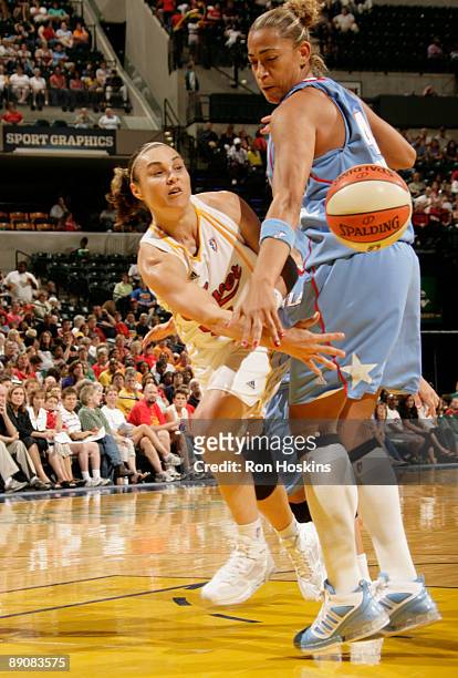 Tully Bevilaqua of the Indiana Fever passes around Erika de Souza of the Atlanta Dream at Conseco Fieldhouse on July 17, 2009 in Indianapolis,...
