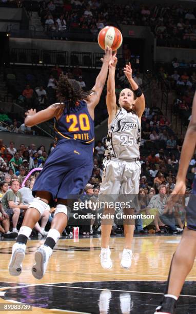 Becky Hammon of the San Antonio Silver Stars shoots against Tan White of the Connecticut Sun on July 17, 2009 at the AT&T Center in San Antonio,...