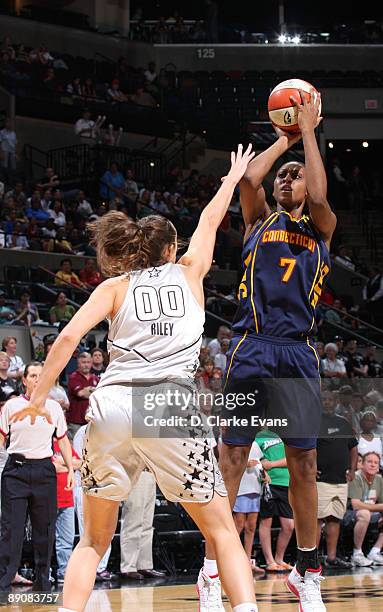 Sandrine Gruda of the Connecticut Sun shoots against Ruth Riley of the San Antonio Silver Stars on July 17, 2009 at the AT&T Center in San Antonio,...