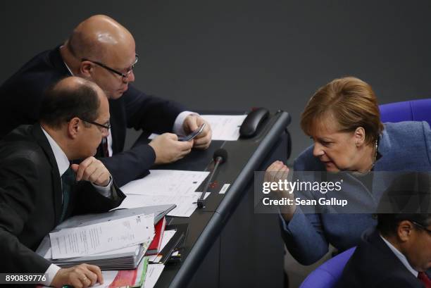 German Chancellor and leader of the German Christian Democarts Angela Merkel speaks with colleagues during debates and votes at the Bundestag over...