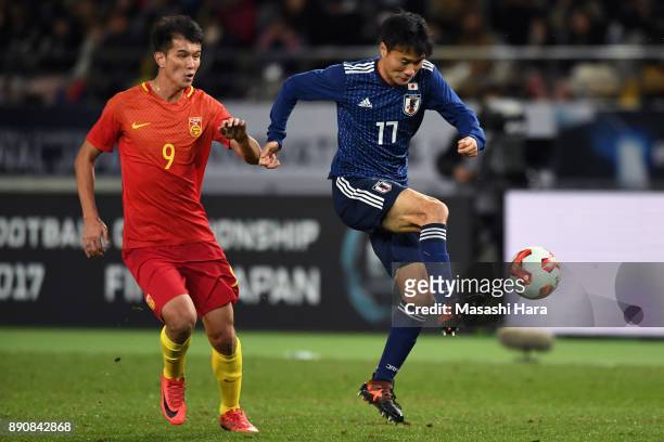 Yasuyuki Konno of Japan controls the ball under pressure of Xiao Zhi of China during the EAFF E-1 Men's Football Championship between Japan and China...