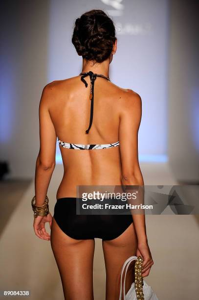 Model walks the runway at the Aqua Di Lara 2010 fashion show during Mercedes-Benz Fashion Week Swim at the Oasis at The Raleigh on July 17, 2009 in...