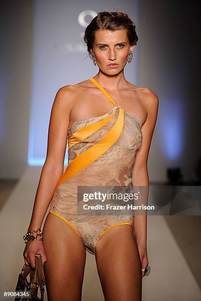 Model walks the runway at the Aqua Di Lara 2010 fashion show during Mercedes-Benz Fashion Week Swim at the Oasis at The Raleigh on July 17, 2009 in...