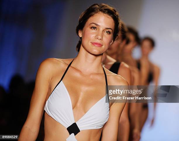 Models walk the runway at the Aqua Di Lara 2010 fashion show during Mercedes-Benz Fashion Week Swim at the Oasis at The Raleigh on July 17, 2009 in...