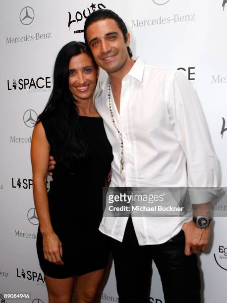Carole Marini and Gilles Marini attend the L*Space by Monica 2010 fashion show after party during Mercedes-Benz Fashion Week Swim at Louis at the...