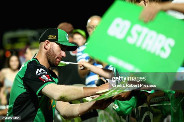 John Hastings of the Melbourne Stars signs autographs during the Big Bash League exhibition match between the Melbourne Stars and the Sydney Thunder...