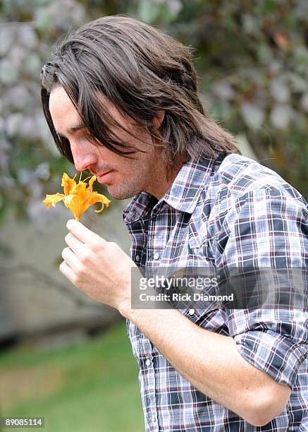 Singer/Songwriter Jake Owen checks out the local yellow flower while taping for GACTV backstage at the 17th Annual Country Thunder USA music festival...