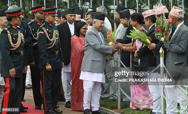 Nepalese Prime Minister Madav Kumar Nepal is welcomed by ministers upon his arrival at the Tribhuvan International Airport in Kathmandu on July 18...