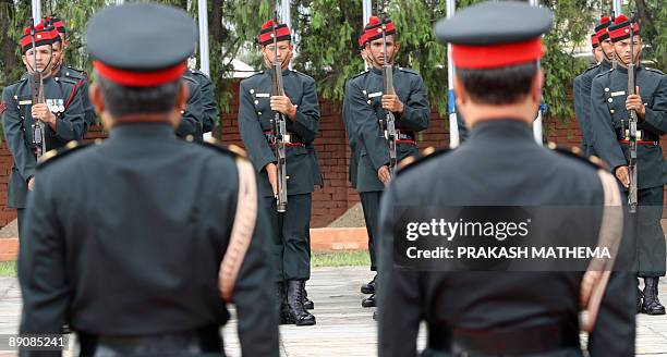 Nepalese Army Cadets perform an official salute to unseen Prime Minister Madav Kumar Nepal upon his arrival at the Tribhuvan International Airport in...