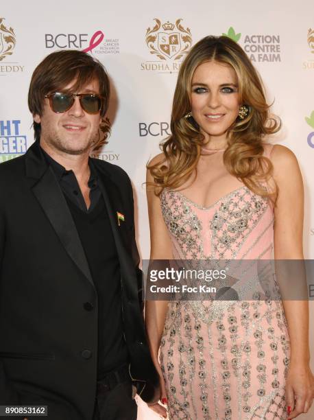 Singer Thomas Dutronc and actress Elizabeth Hurley attend The Fight Hunger and The Breast Cancer Research Foundations Auction Cocktail at Shangri La...