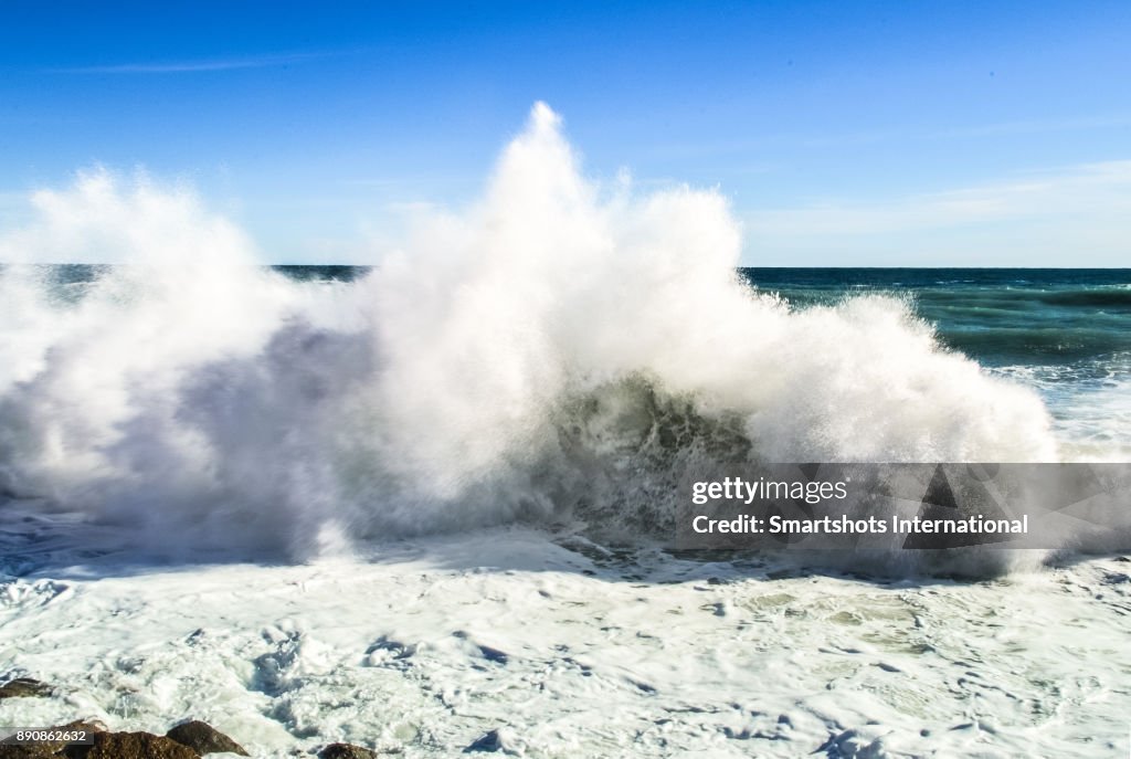 Scenic wave breaking at high tide in the Mediterranean sea near Genoa, Liguria, Italy