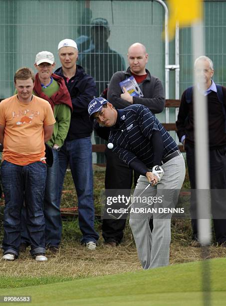 English golfer David Howell chips onto the 1st green, on the third day of the 138th British Open Championship at Turnberry Golf Course in south west...