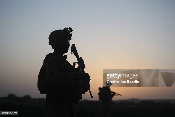 Marines with the 2nd Marine Expeditionary Brigade, RCT 2nd Battalion 8th Marines Echo Co. Step off in the early morning during an operation to push...