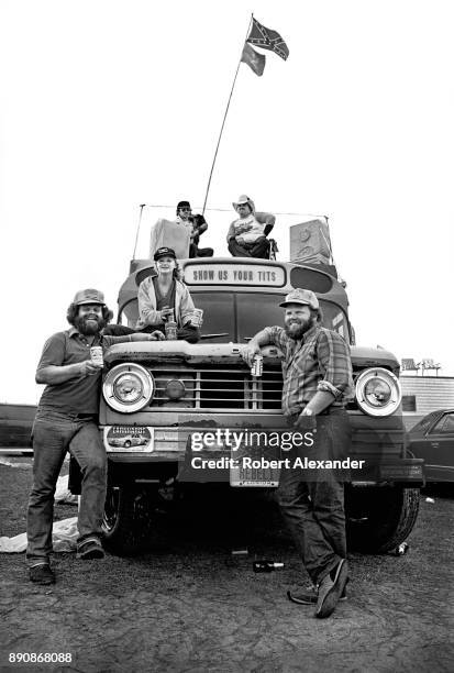 Fans of NASCAR driver Dale Earnhardt Sr., relax at their bus parked in the infield at Daytona International Speedway prior to the start of the 1980...