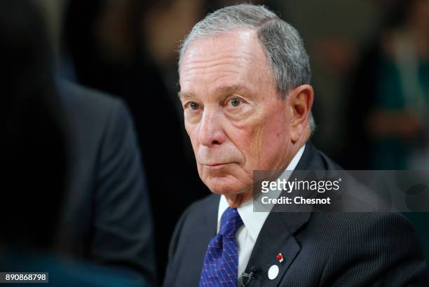 Special envoy to the United Nations for climate change Michael Bloomberg speaks to a journalist during the One Planet Summit at the Seine Musicale on...