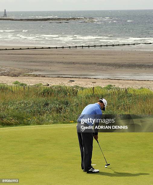 Golfer Zach Johnson putts on the 4th green, on the third day of the 138th British Open Championship at Turnberry Golf Course in south west Scotland,...
