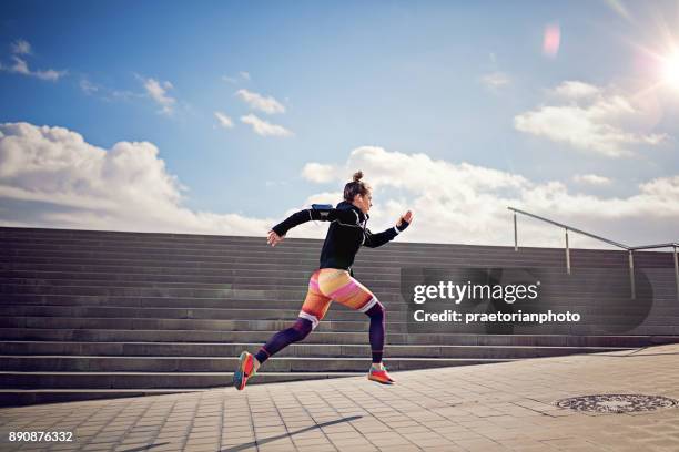 runner girl is sprinting - girl with earphones stock pictures, royalty-free photos & images