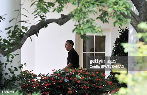 President Barack Obama leaves the Oval office to board the Marine One helicopter from the South Lawn at the White House en route to Camp David on...