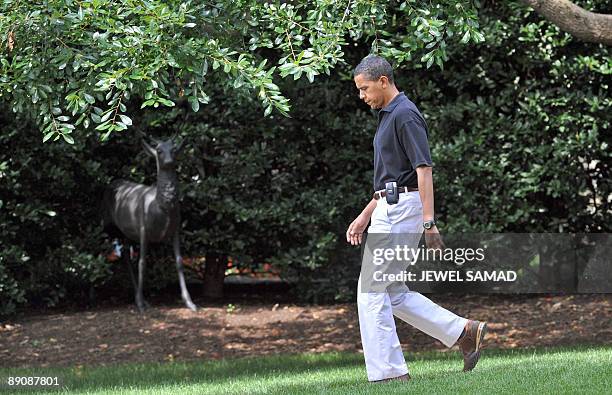 President Barack Obama leaves the Oval office to board the Marine One helicopter from the South Lawn at the White House en route to Camp David on...