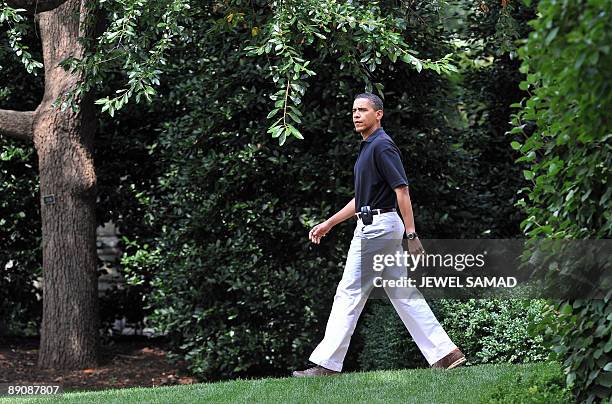 President Barack Obama leaves the Oval office to board the Marine One helicopter from the South Lawn at the White House en route to Camp David on...