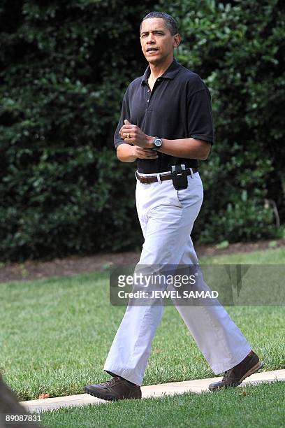 President Barack Obama leaves the Oval office to board the Marine One helicopter from the South Lawn at the White House en route to Camp David on...