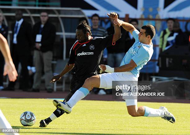 Manchester City's Tal Ben Haim tries to block Orlando Pirates' Siphelele Mtllembu during their 2009 Vodacom Challenge football match at Peter Mokaba...