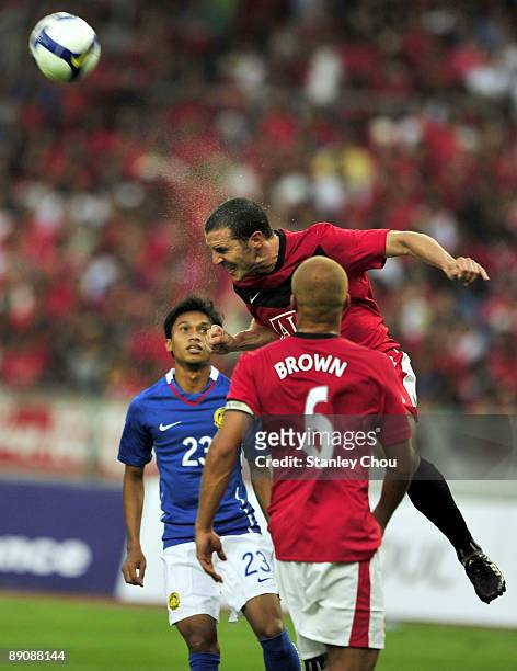 John O'shea of Manchester United wins the header from Baddrol Bakhtiar of Malaysia XI while West Brown looks on during the pre-season friendly match...