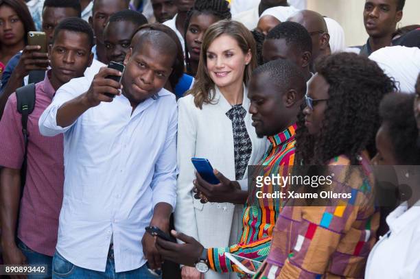 Queen Letizia of Spain poses for a selfie with a student during her visit to the Cervantes Institute on December 12, 2017 in Dakar, Senegal. Queen...