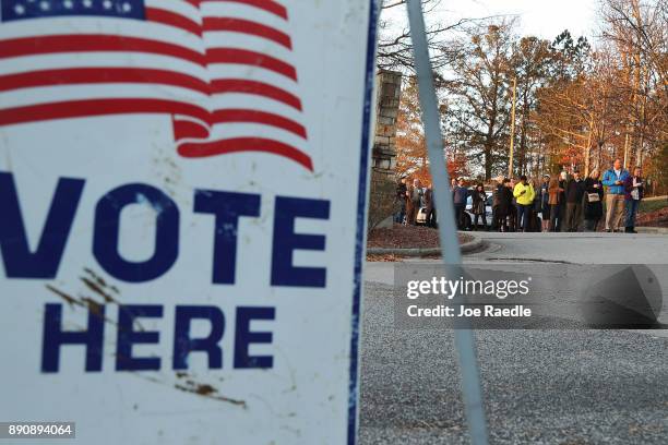 Voters wait in line to cast their ballot at a polling station setup in the St Thomas Episcopal Church on December 12, 2017 in Birmingham, Alabama....